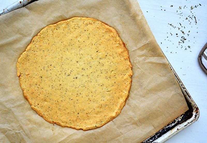 A browning, less-than-perfect cauliflower is the starting point for this pizza crust recipe. Top the crust with any ingredients from your kitchen that need to be used up to make a “garbage pizza.”