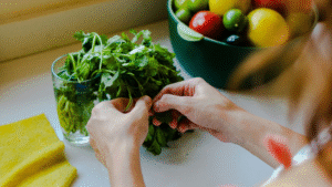 woman picking cilantro leaves from the bunch in their kitchen