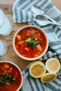 minestrone soup on table with lemon wedge