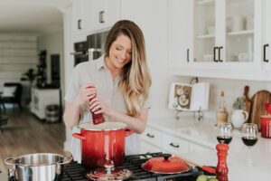 woman seasoning pot in the kitchen
